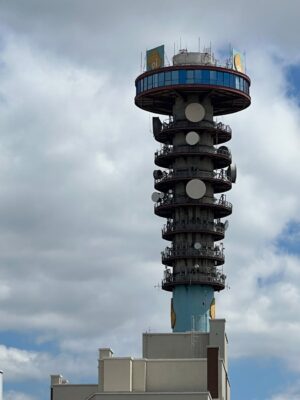 dramatic urban telecommunications tower under clouds